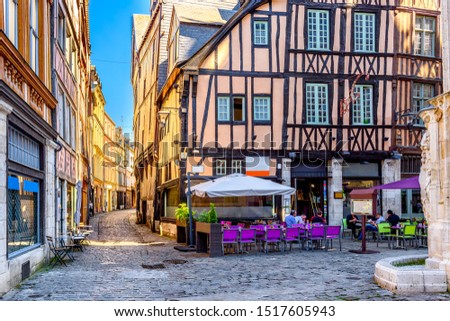 Cozy street with timber framing houses and tables of restaurant in Rouen, Normandy, France. Architecture and landmarks of Rouen. Cityscape of Rouen Royalty-Free Stock Photo #1517605943