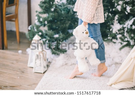 vintage style photo - Girl with vintage bear preparing to Christmas near old fashioned new year eve with Christmas decorations, toys, gifts and balloons
