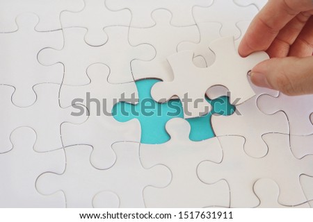 Hands with jigsaw puzzle pieces, Business strategy planning, Alzheimer's disease,  Autism and mental health, social distancing concept