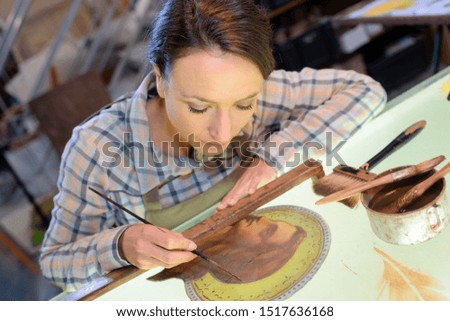 an artist doing detailed painting