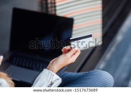 Fast shopping online. Close up photo, credit card and laptop computer to perform shopping online by inputting card.