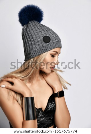 Fashion art photo of young grunge style woman gray winter hat on white background