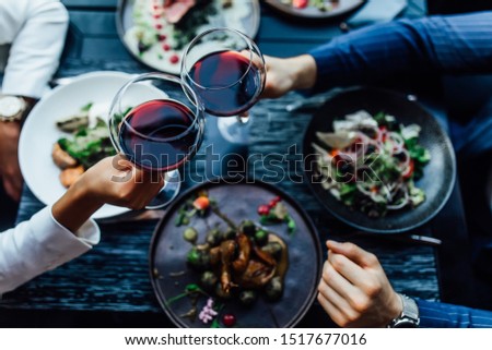 Restaurant table set main dish steak fish cuisine fine dinning white wine glass cooler candle light wooden table atmosphere menu. Royalty-Free Stock Photo #1517677016