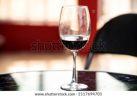 beautiful picture of a glass of red wine lying on the table