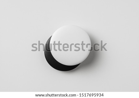 Design concept - top view of 2 black & white badge isolated on white background for mockup, it's real photo, not 3D render