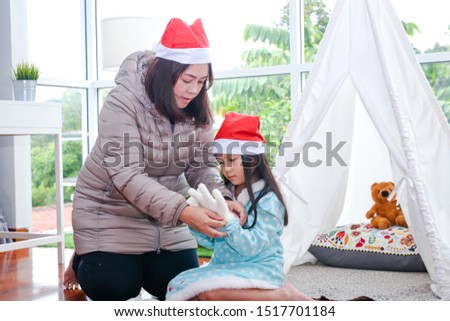A happy mother and daughter at Christmas. The concept of the celebration of the birth of Jesus.