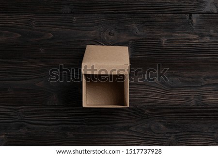 Cardboard box on a dark rustic wooden background