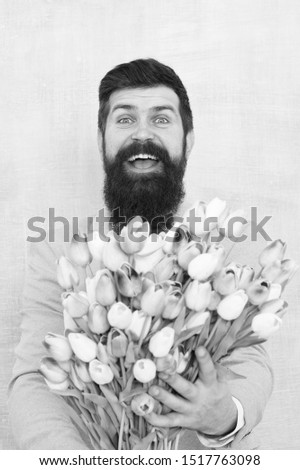 Flowers delivery. Gentleman romantic date. Birthday greetings. Best flowers for girlfriend. Spring holiday. Man bearded suit bow tie hold tulip flowers bouquet. Gentleman romantic surprise for her.