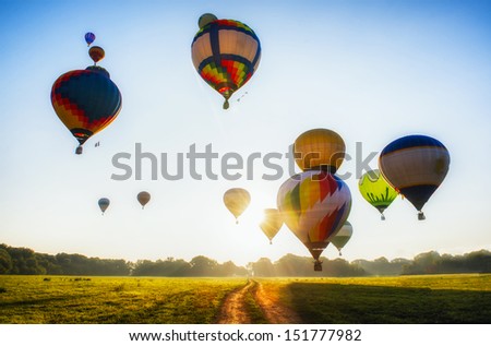 A lot of balloons start they flight over field and forest Royalty-Free Stock Photo #151777982