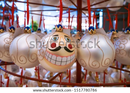 The spheres are hung on the furniture in the Christmas ornaments shop.