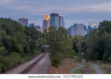A Compressed Shot of Train Tracks and Walking Paths Leading toward Downtown Minneapolis during an Early Fall Blue Hour