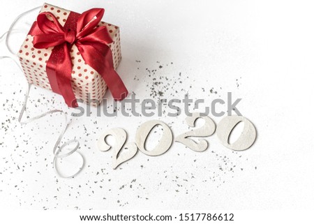 New year 2020 white festive background with gift tied with red ribbon. New year 2020 concept. . Copy space.