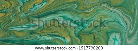 art photography of abstract marbleized effect background. emerald green, turquoise and gold creative colors. Beautiful paint.