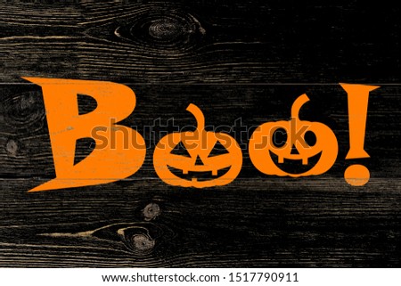 BOO!, jack-o-lantern pumpkin silhouettes painted on black wooden wall