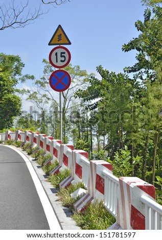 Mountain road bending, warning sign and speed limit 