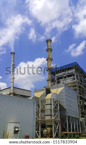 Beautiful blue sky with cloud over smokestack of power boiler in factory