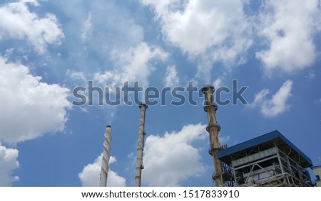 Beautiful blue sky with cloud over smokestack of power boiler in factory