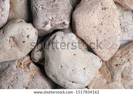 A handful of sea stones for decoration. Pebbles rocks Backgrounds Concept