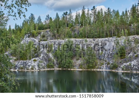 Water landscape of a mountain park. The picturesque landscape of the mountain natural park Ruskeala. Visible are rocks, a lake, coniferous forest, mountains, wildlife. Russia, Karelia