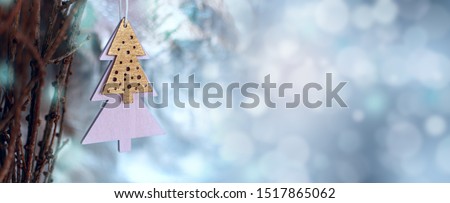 Christmas decoration in minimal style, wooden christmas tree shape. Wide banner, magickal bokeh background, space for text.