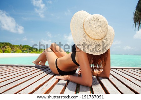 Young fashion woman relaxing on the beach