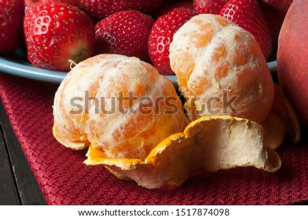 Tangerine and strawberries in a macro photography