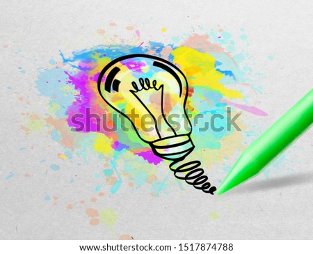Drawing colorful bulb and multimedia symbols on white paper
