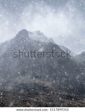 Stunning moody dramatic Winter landscape mountain image of snowcapped Y Garn in Snowdonia
