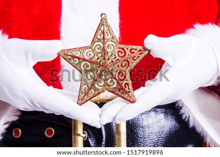 Christmas and New Year greeting card, Santa Claus holding Christmas star