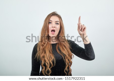 girl brown haired in black dress over isolated white background shows emotions