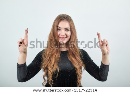 girl brown haired in black dress over isolated white background shows emotions