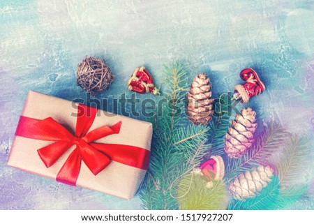 Christmas or New Year background with defocused multicolor Christmas lights, pine branch and gift boxes, top view with copy space.