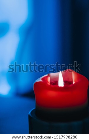 Happy holidays, greeting card backdrop and winter season concept - Red holiday candle on blue background, luxury branding design and decoration for Christmas, New Years Eve and Valentines Day