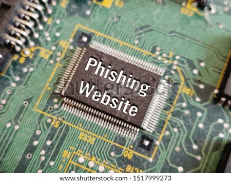 conceptual image and word - PHISHING WEBSITE with blurred circuit board as background/selective focus. 
