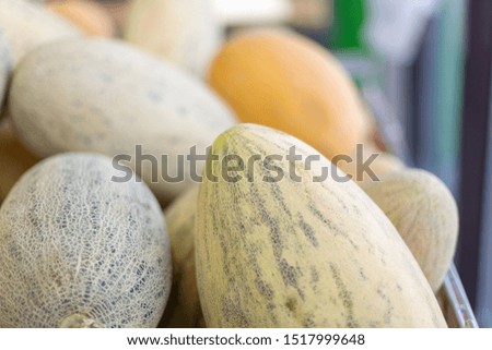 Food photo of fruit asian melon. Texture background colorful food fruit yellow melons. Yellow melon fruit food product image at supermarket counter.