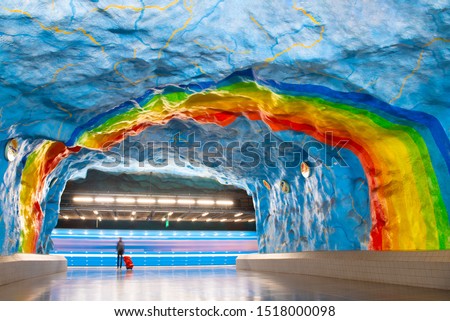 Passenger with a trunk at the Stadium metro station in Stockholm waiting for an underground train, Sweden. Royalty-Free Stock Photo #1518000098