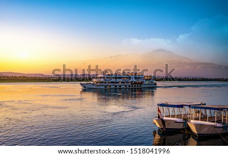 River Nile and ship at sunset in Aswan Royalty-Free Stock Photo #1518041996