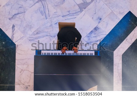 Musician playing a musical instrument, top view.