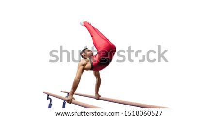Male athlete doing a complicated exciting trick on parallel bars on white background. Isolated Man perform stunt in bright sports clothes