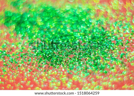 Blurred Christmas background in red and green colors. Blurred sparkles, spectacular beautiful bokeh. Abstract image, minimalism, bright colors, place for text.
