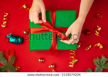 Preparing for Christmas holidays, woman with a gift in her hands