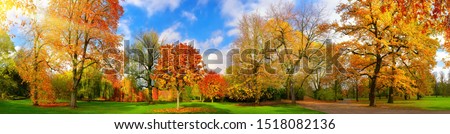 Wide colorful panorama of a gorgeous park in autumn, a tranquil and happy outdoor scene Royalty-Free Stock Photo #1518082136
