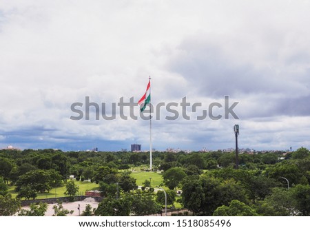 Indian Flag fluttering in the wind under monsoon clouds at Central Park in Jaipur, Rajasthan