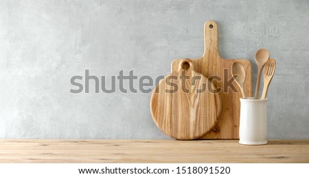 Contemporary kitchen background with kitchen utensils standing on wooden countertop,  blank space for a text, front view Royalty-Free Stock Photo #1518091520