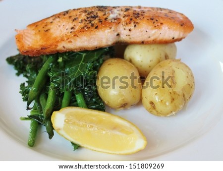 salmon fish with new potatoes, seasonal greens and a lemon wedge, Balanced meal Grilled pan seared Atlantic Scottish salmon stock, photo, photograph, picture, image