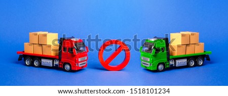 Prohibition sign NO between two trucks. Embargo trade wars. Restriction on importation, ban transit export dual-use goods to countries under sanctions. transport companies.