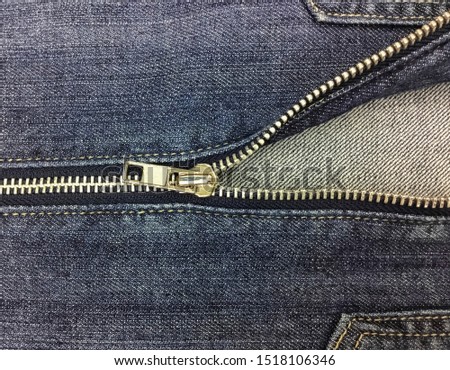 zipper on blue jeans background