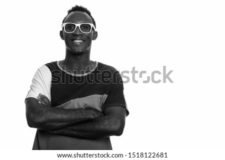 Young happy African man smiling with arms crossed
