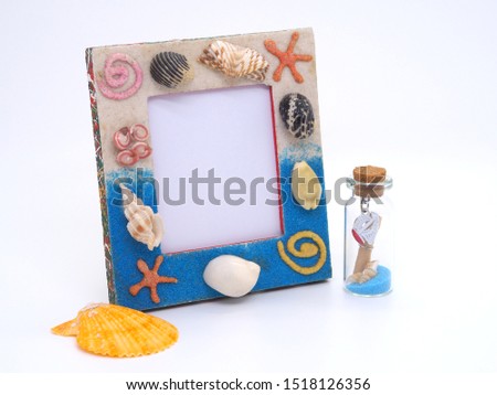 Blue picture frame  sea shell isolated on white background. 
