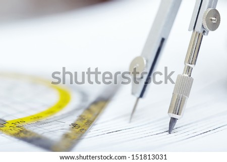 Compasses and ruler on a graphic. Extremely close-up photo
